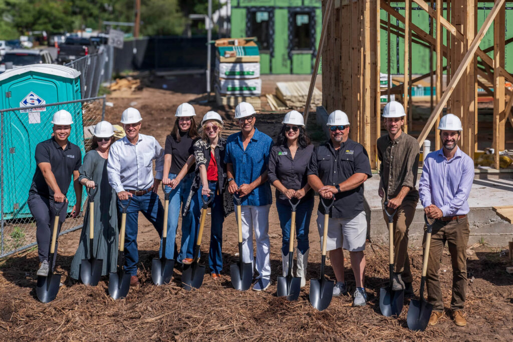Outside shot of Development team with shovels on site for a groundbreaking event for a new development named Mira on Springdale in East Austin Texas.