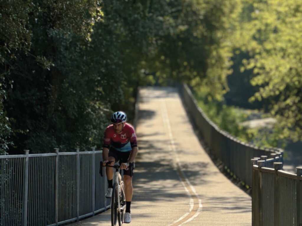 Outside shot of a bicyclist on the bike trail in East Austin.