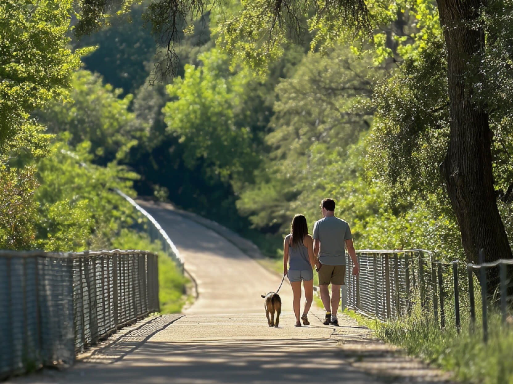 Couple walking in nature trail in East Austin park – Mira Residences