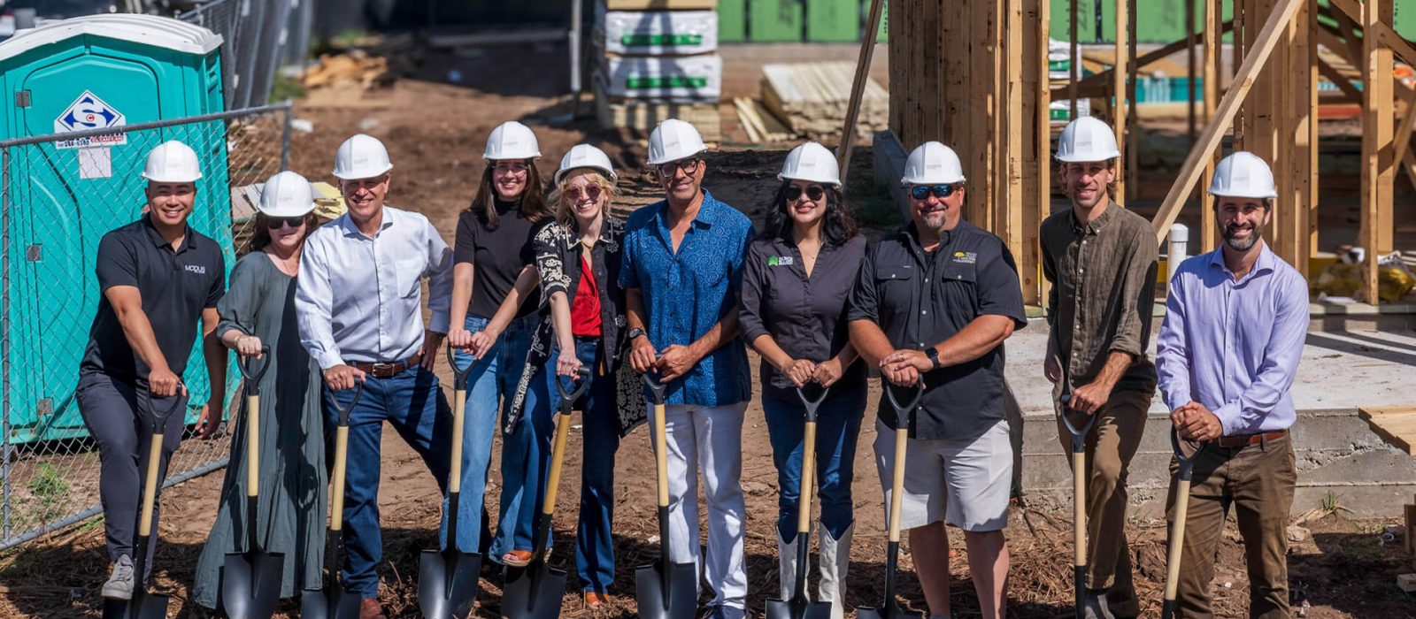 Outside shot of Development team with shovels on site for a groundbreaking event for a new development named Mira on Springdale in East Austin Texas.